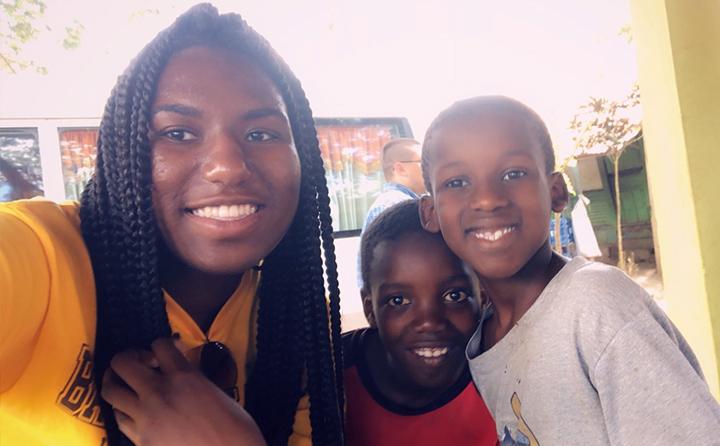 BW student Autumn Richards (right) with two children in the Dominican Republic on an Honors Program trip